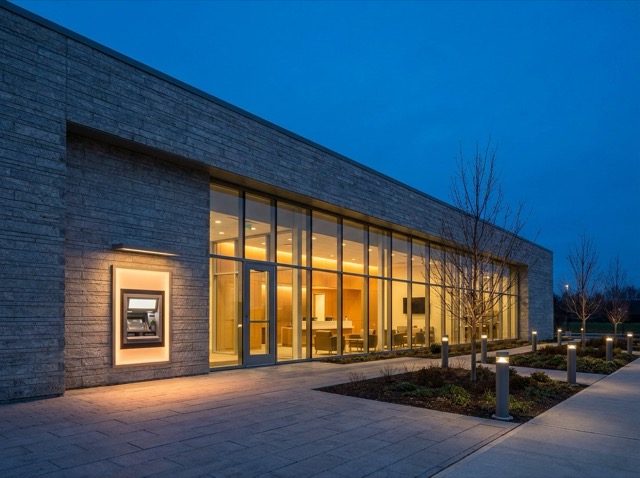A bank branch at dusk with a lit lobby